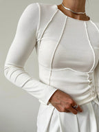 Top beige maniche lunghe con drappeggio asimmetrico