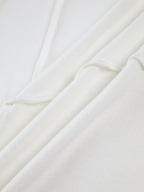 Top beige maniche lunghe con drappeggio asimmetrico