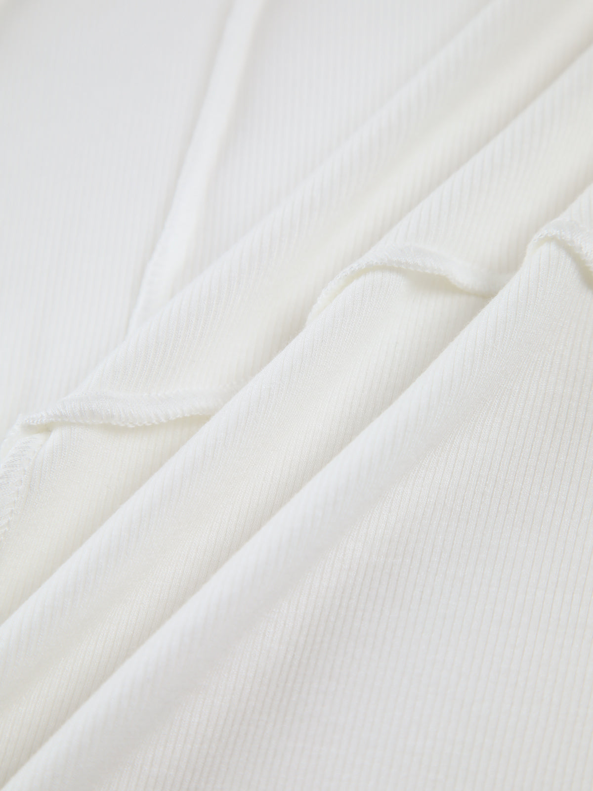 Top beige maniche lunghe con drappeggio asimmetrico
